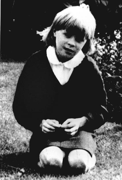 A grayscale photo of a young girl, Sarah Harper, kneeling in a garden.