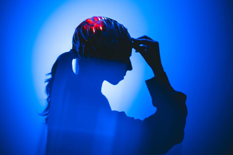 Profile headshot silhouette in vibrant abstract light, suggesting innovation and contemplation, topics of brain and cognitive functions