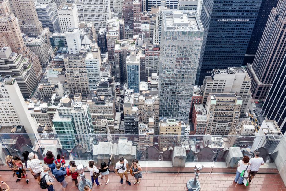 People viewing the Manhattan skyline from Top of the Rock observation deck.