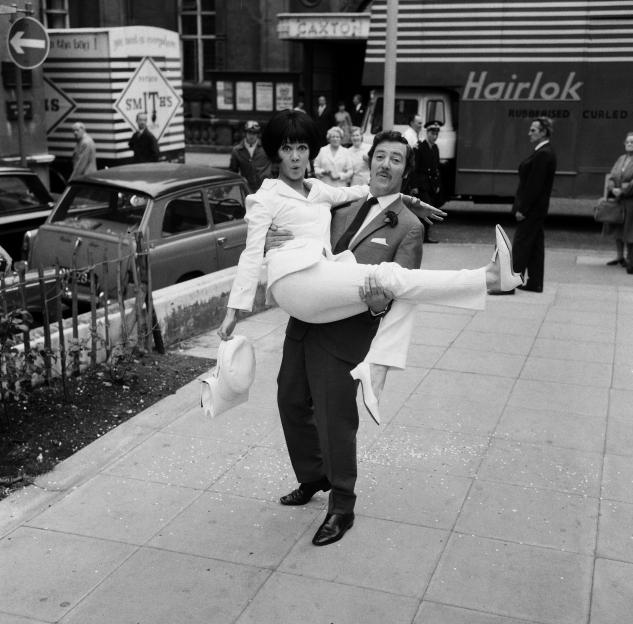 Robin Hunter carrying Amanda Barrie in his arms on their wedding day.