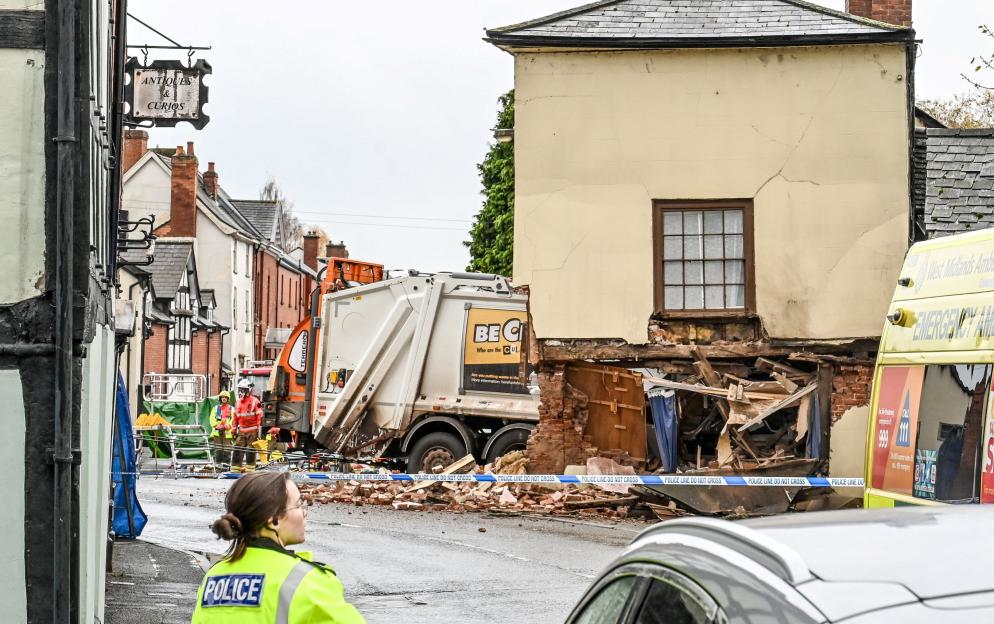Emergency services rush to street after bin lorry smashes through side of house