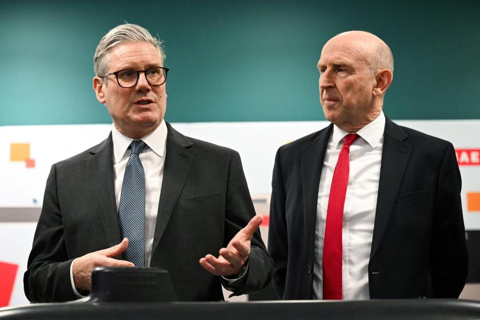 Britain's Prime Minister Keir Starmer and Britain's Defence Secretary John Healey speaking next to a submarine model.