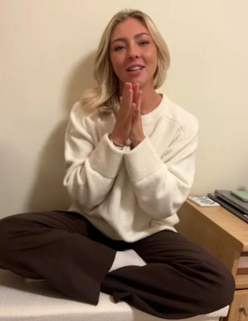 Lucy Wilde sitting with hands pressed together.