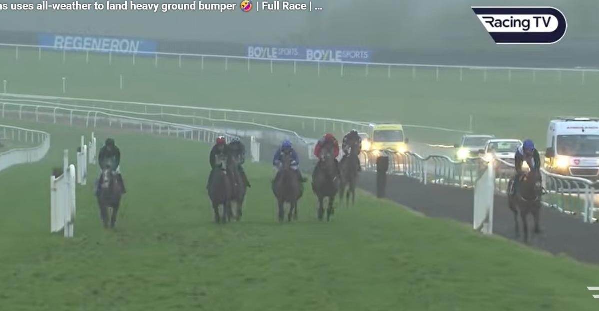 Horse race with multiple jockeys on a foggy track, with "Racing TV" logo in the top right.