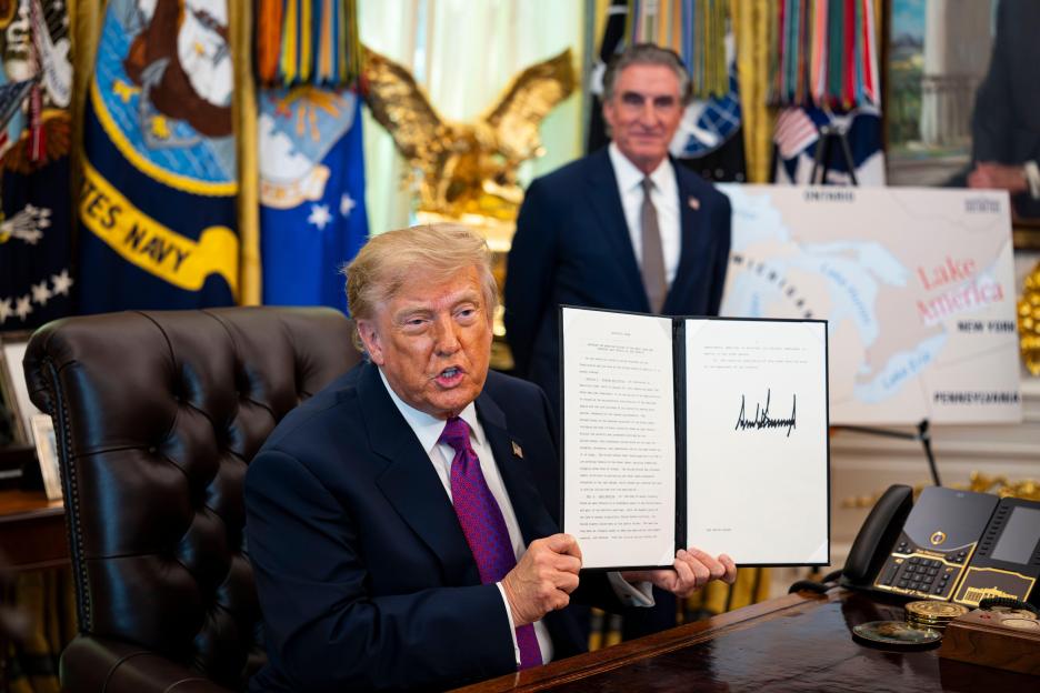 WASHINGTON, DC - AUGUST 27: United States President Donald J Trump shows a signed executive order to rename Lake Ontario as Lake America, amid a recent trade war, in the Oval Office of the White House in Washington, DC.Credit: Al Drago / Pool via CNP