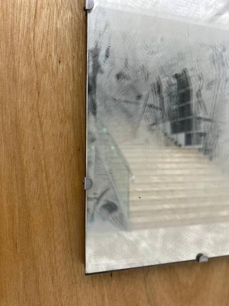 Artist Chen Sung-chih’s piece, "Inverted Syntax – 16", displaying a smudged mirror on a wooden board.