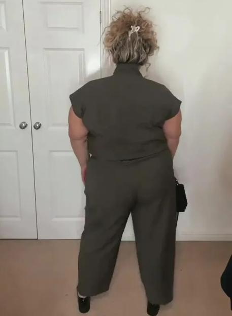 A woman wearing a dark green F&F co-ord from behind, showing it fits a size 22.